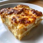 Close-up of a rich slice of Texas de Brazil potatoes au gratin with a golden-brown, cheesy crust.